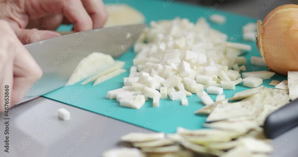 Cooking at home, celery root chopping using kitchen knife, close-up Cooking at home, celery root chopping using kitchen knife, close-up