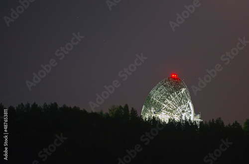 Radio telescope antenna against the background of the night starry sky