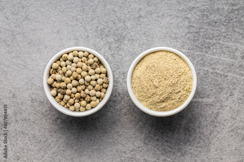White ground pepper and whole peppercorn spice in bowl. White ground pepper and whole peppercorn spice in bowl.