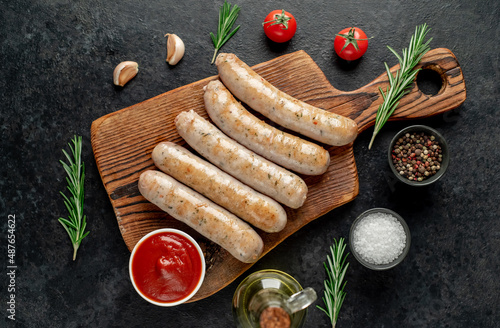 grilled sausages on stone background