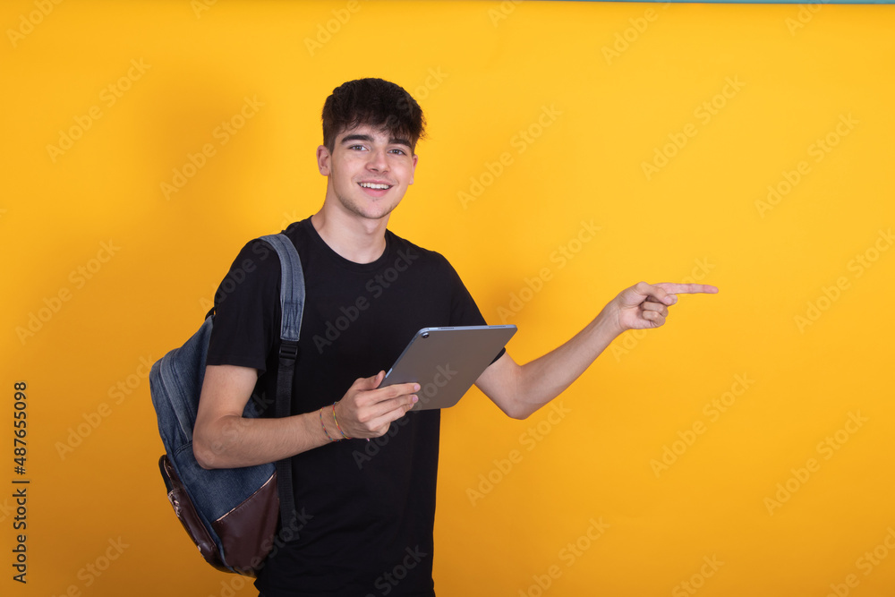 student with backpack and digital tablet isolated on background pointing student with backpack and digital tablet isolated on background pointing