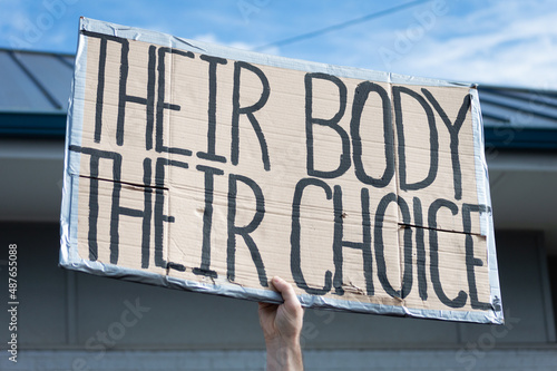 A hand holding a sign supporting pro-choice during a planned parenthood rally for abortion justice. photo