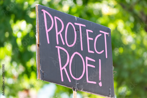 A hand holding a sign supporting protecting Roe v. Wade during a planned parenthood rally for abortion justice. photo