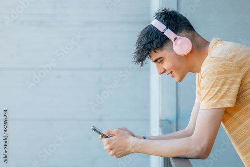 young teenager boy with headphones and mobile phone