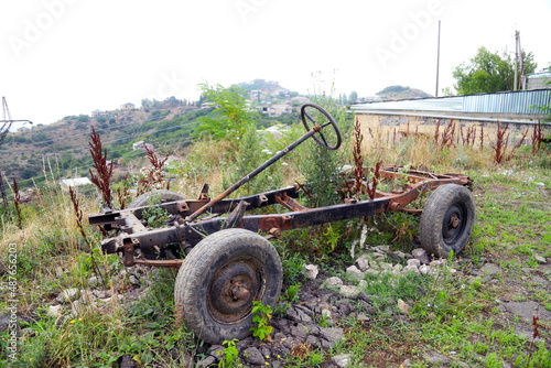 Rusty chassis with wheels of an old SUV. angle view