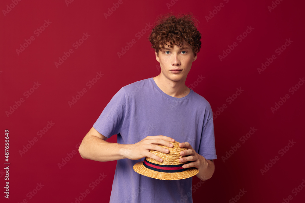 young guy fashion posing hand gestures stylish hat red background unaltered young guy fashion posing hand gestures stylish hat red background unaltered