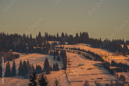 Amazing sunrise. Winter forest. High mountains with snow white peaks. Location place Carpathian, Vatra Dornei, Bucovina, Suceava, Romania, Europe.