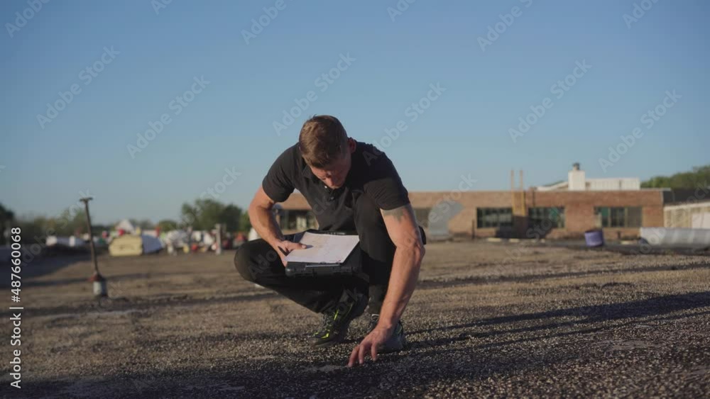 Roofing project manager supervising a flat roof build Roofing project manager supervising a flat roof build