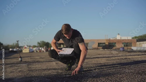 Roofing project manager supervising a flat roof build