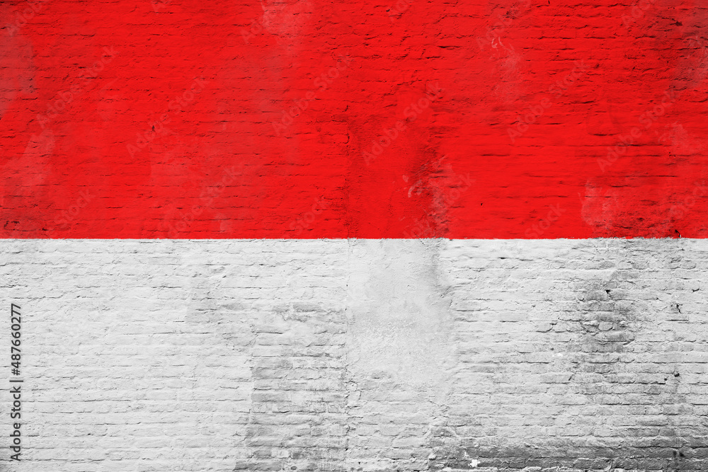 Full frame photo of a weathered flag of Indonesia painted on a plastered brick wall. Full frame photo of a weathered flag of Indonesia painted on a plastered brick wall.