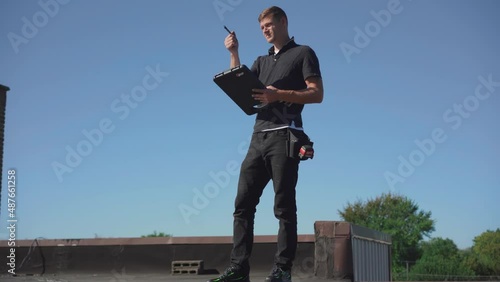 Roofing inspector performing a routine inspection on a low slope roof
