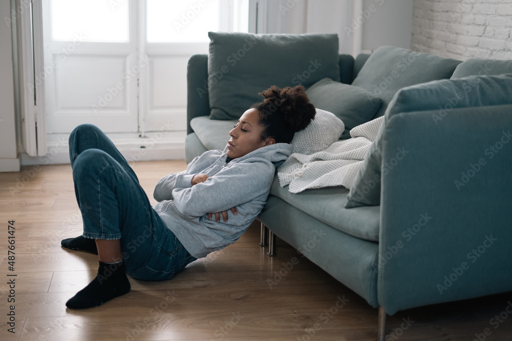 Obraz premium Sad black woman suffering from depression symptoms feeling distressed alone at home