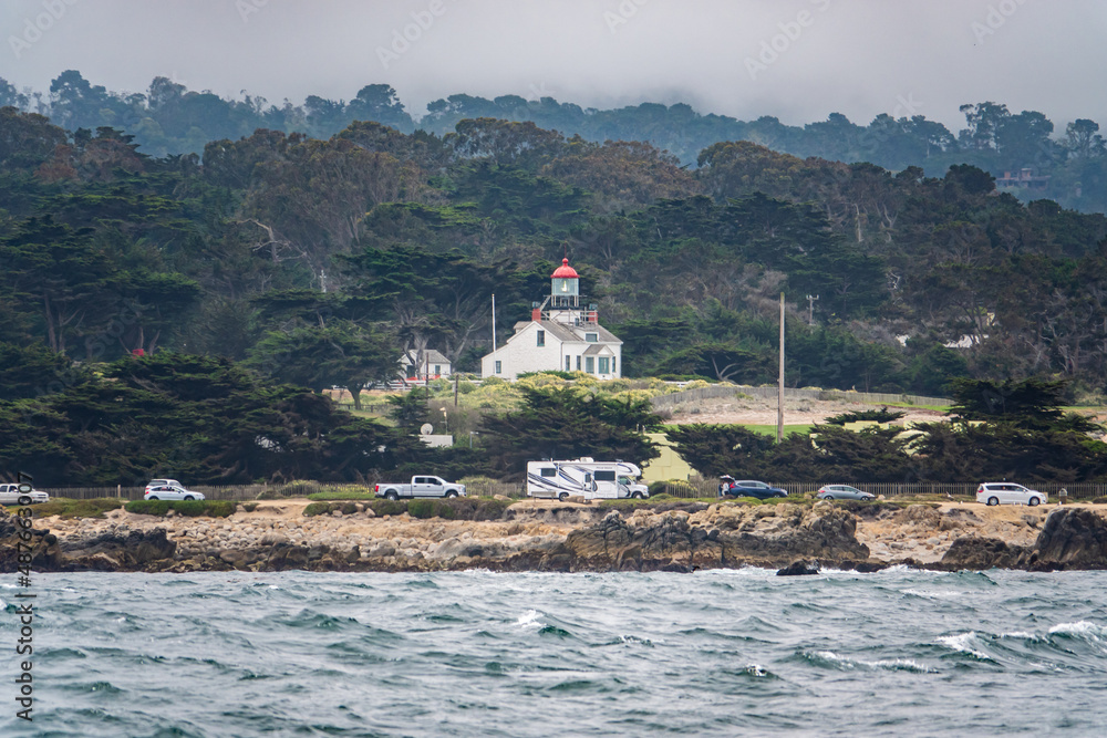 Point Pinos Historic Lighthouse in Pacific Grove California as viewed from a passing boat. 