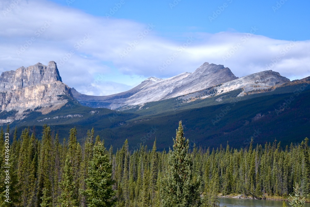 the Canadian Rockies under a cloud filled blue sky