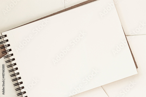 Open blank sheet of sketchbook on spiral, light background, copy space photo