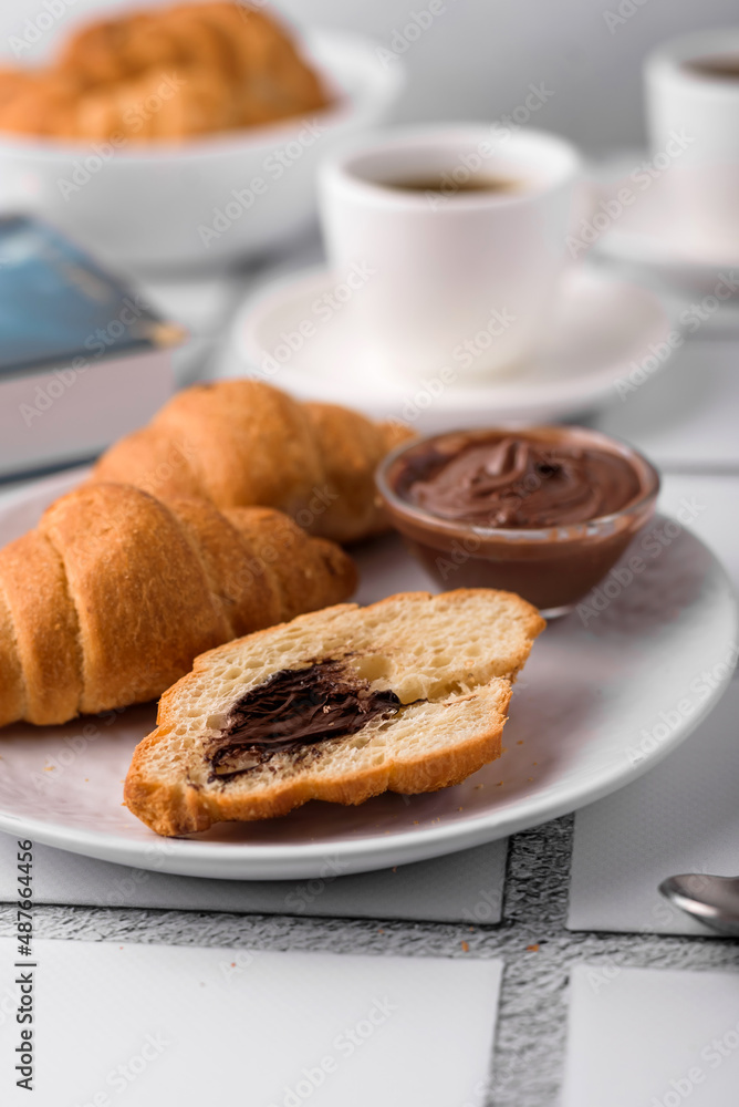 coffee and croissants, chocolate cream, french press on the table, morning breakfast coffee and croissants, chocolate cream, french press on the table, morning breakfast