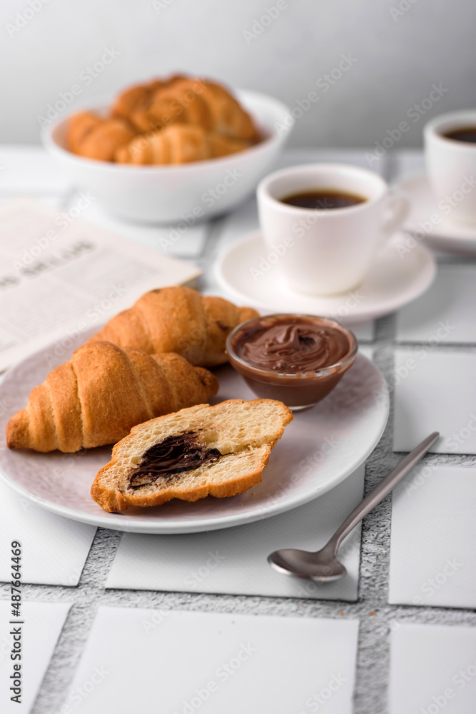 coffee and croissants, chocolate cream, french press on the table, morning breakfast coffee and croissants, chocolate cream, french press on the table, morning breakfast