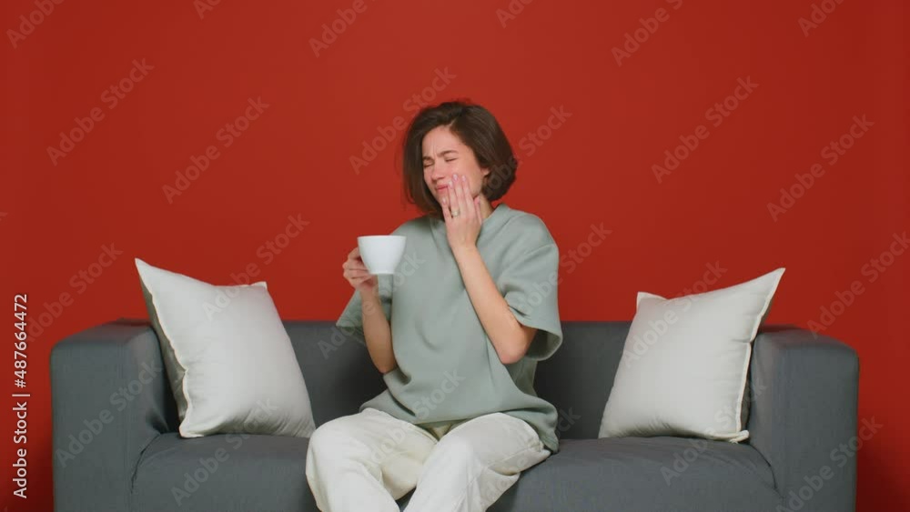 Tooth ache. Young girl drink hot tea and feel acute sudden pain suffer