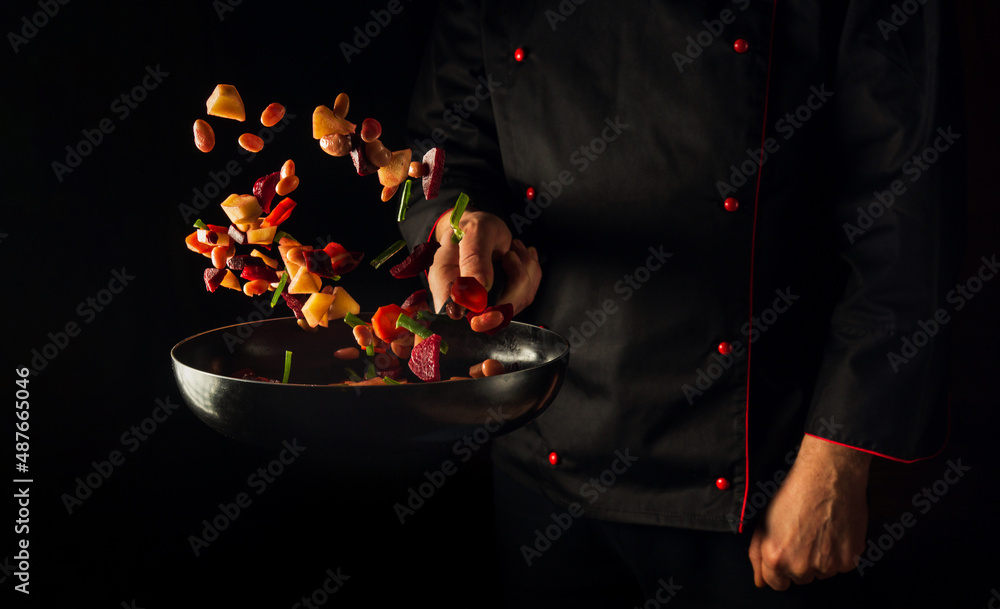 Cooking vegetables by chef hands on dark background copy space. Food concept. Vegetable menu for the hotel - obrazy, fototapety, plakaty 