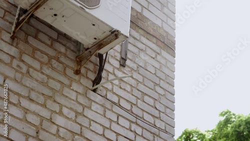 Compressor unit is installed outside the building. Air conditioning, water leaking.