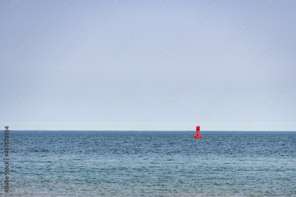 Red  Buoy in the lake with blue sky background
