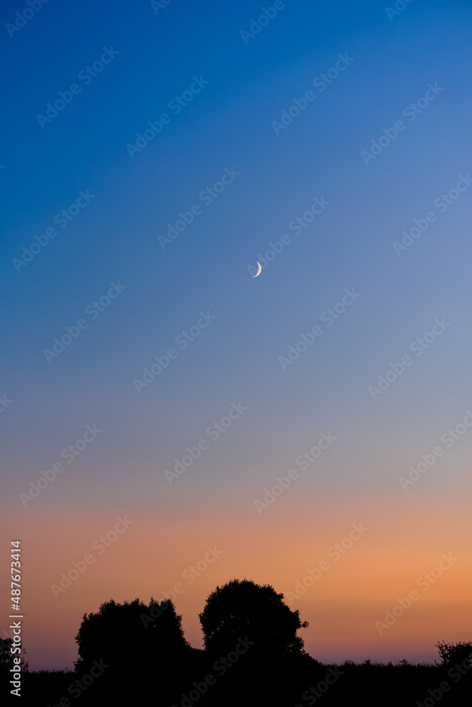 sky in dark blue twilight, Twilight sky in the evening with sunset and beautiful sunlight on a dark cloud and a crescent moon sky in dark blue twilight, Twilight sky in the evening with sunset and beautiful sunlight on a dark cloud and a crescent moon