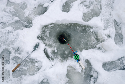 ice fishing. winter fishing. The fishing rod lies in the snow