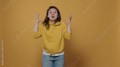Portrait of angry woman feeling frustrated and mad doing exasperated hand gesture in studio. Furious young stressed person having a breakdown acting aggresive showing unpleasant reaction.