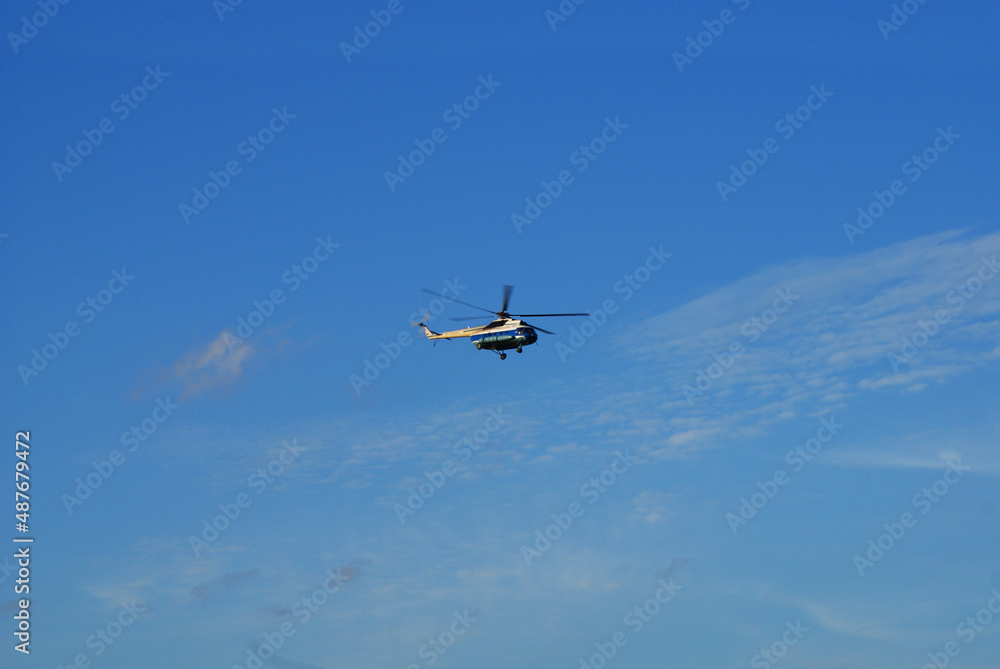Military helicopter in the blue sky with clouds. Military helicopter in the blue sky with clouds.