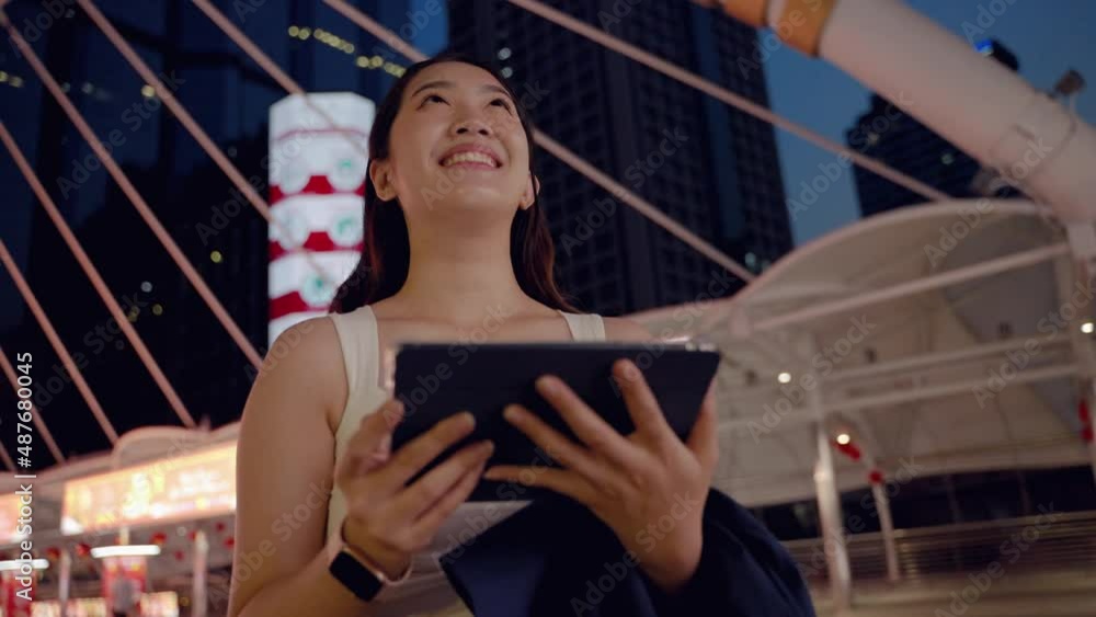 at night,young Asian woman happily plays with the tablet .She looks forward with hopes and dreams, a technology device of today in the middle of an urban society with buildings a in the backdrop.
at night,young Asian woman happily plays with the tablet .She looks forward with hopes and dreams, a technology device of today in the middle of an urban society with buildings a in the backdrop.