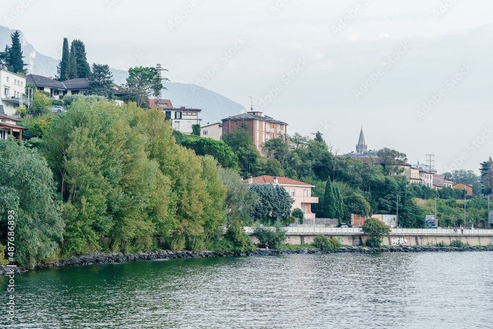 Milan, Italy - September 15, 2021: embankment at Como lake with beautiful landscape scenery at Lecco - travel destination in Lombardia, Italy