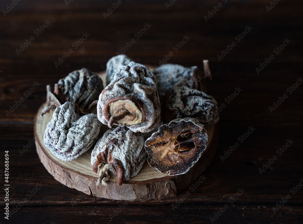 Dried persimmon on a wooden background. Healthy diet Dried persimmon on a wooden background. Healthy diet