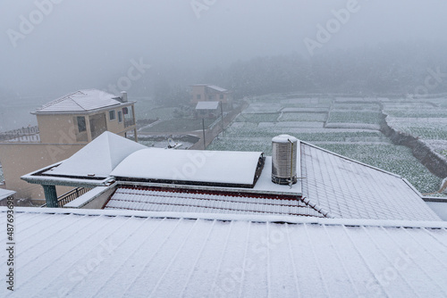 Rural roof tiles covered with white snow