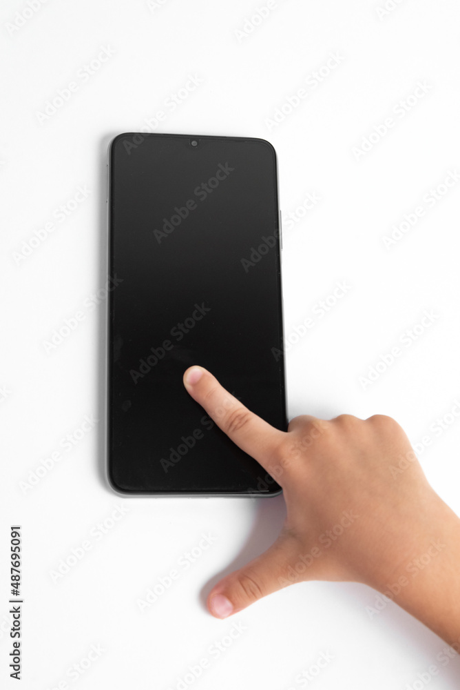 Child holding cellphone over white background Child holding cellphone over white background