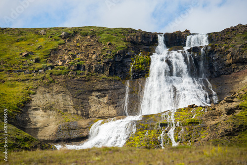 Rjukandi waterfalls in sunshine also called Yst i-Rjukandi with cliffs and waterfalls in Eastern Iceland near Egilsstadi