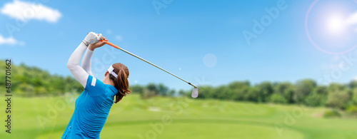 Professional woman golfer teeing golf in golf tournament competition at golf course for winner.