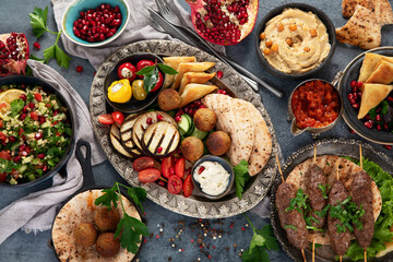 Arabic food assortment on dark background.