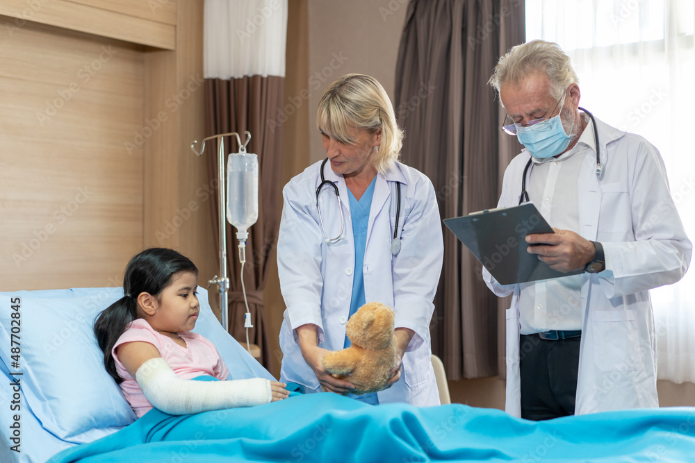 Pediatrician is closely caring and asking about sick girls symptoms, health concepts and child care. Pediatrician is closely caring and asking about sick girls symptoms, health concepts and child care.