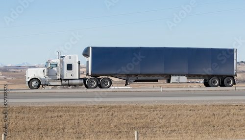 Heavy Cargo on the Road. A truck hauling freight along a highway. Taken in Alberta, Canada