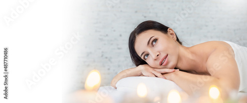 Closeup beautiful caucasian young  woman lying down on massage beds at Asian luxury spa and wellness center. Portrait of beauty asian woman relaxing with copy space, healthcare lifestyle banner.