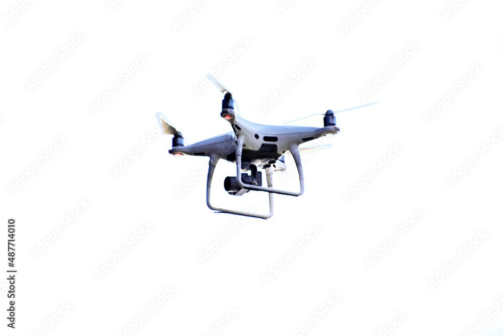 Close-up of drone is flaying against isolate white background Close-up of drone is flaying against isolate white background