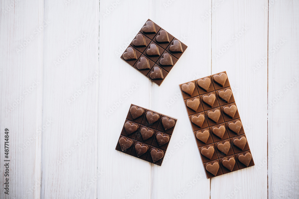 craft homemade milk and dark chocolate on a white wooden background craft homemade milk and dark chocolate on a white wooden background