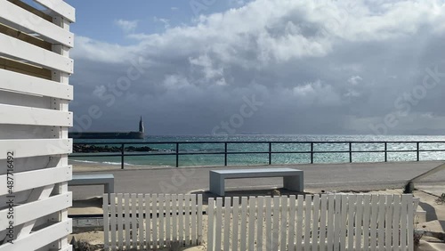 Lighthouse in Tarifa and dramatic sky, Andalusia, Spain.Tarifa is one of the world's most popular destinations for windsports.	 photo