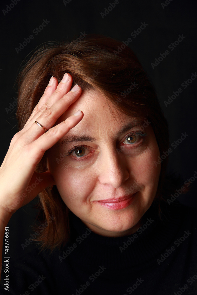 Portrait of a middle aged woman on a black background. Portrait of a middle aged woman on a black background.
