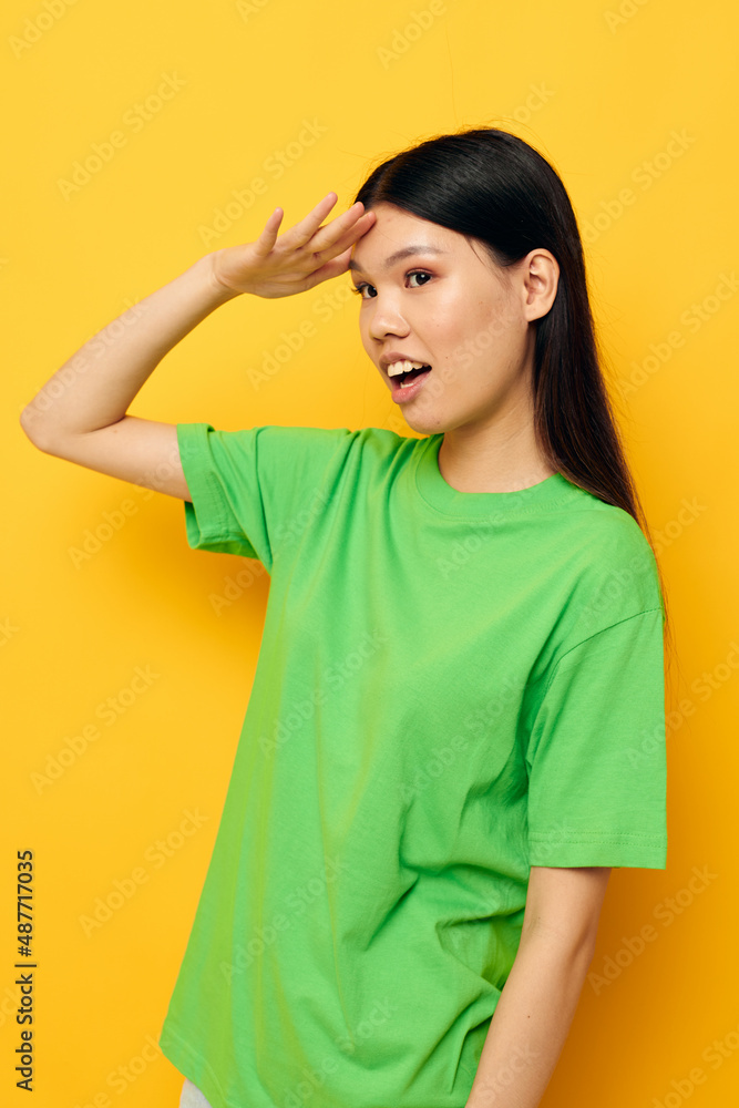 Portrait Asian beautiful young woman posing in green t-shirt emotions copy-space studio model unaltered Portrait Asian beautiful young woman posing in green t-shirt emotions copy-space studio model unaltered