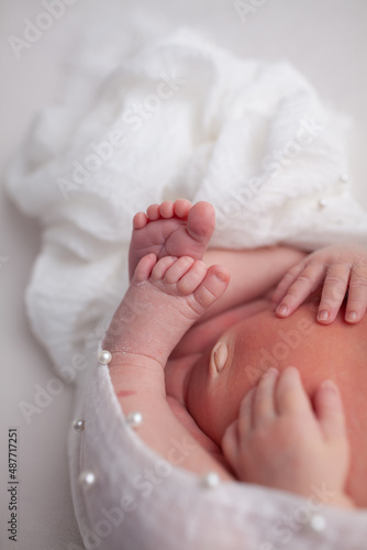 Baby little feet and toes on white background 