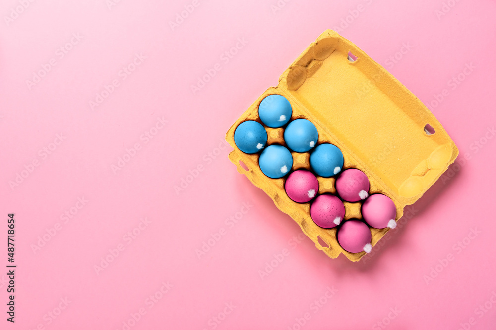 Package of chicken eggs with white fluffy tails as a Easter bunnies painted in various colors on pink background. Copy space. Banner. Religion holiday concept. Mockup design. Neon minimalist style Package of chicken eggs with white fluffy tails as a Easter bunnies painted in various colors on pink background. Copy space. Banner. Religion holiday concept. Mockup design. Neon minimalist style