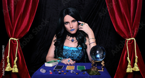 Fotografie Psychic with Crystal Ball and tarot cards in Red Velvet Tent
