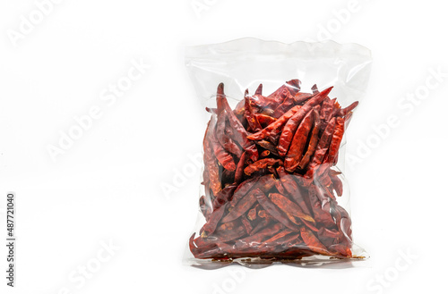 Dried chilli in cleared plastic packaging for sale on white background, front view of the dried chilli cleared plastic bag for label design photo