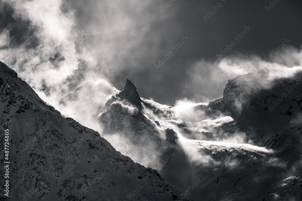 view of high mountains in the snow, strong wind in the mountains